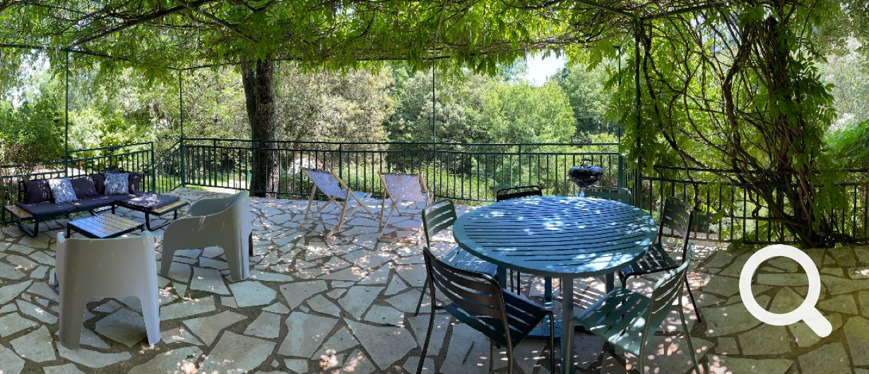 Coin repas et salon sur la terrasse ombragée de la location de vacances de Veyrignac
